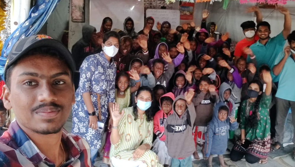 Students distribute winter clothing among slum dwellers